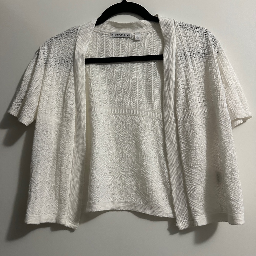 White cardigan with short sleeves and a crochet pattern